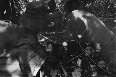 A photograph of Platoon strength N.W. 1ATF 'Operation Atherton' 10 December 1969. 1 Platoon, A Company, 8 RAR under heavy machin gun fire. 