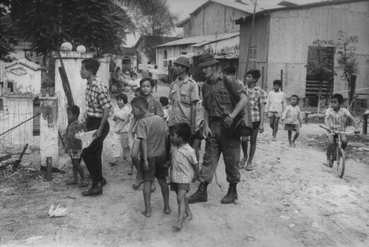 A photograph of a digger from the 1st Australian Field Hygiene Unit accompanies the Phuoc Tuy Province Health Inspector Vu Dien Thien. 