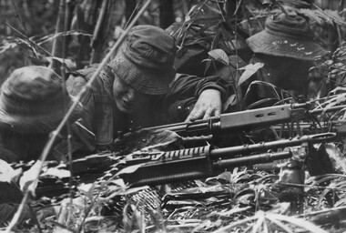 A photograph of of Platoon strength N.W. 1ATF 'Operation Atherton' , 1 Platoon, A Company, 8 RAR, a Platoon M60 prepares to return  fire. 