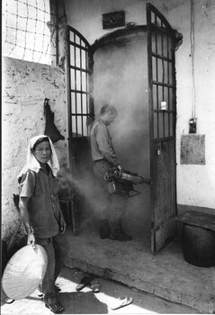 A photograph of Cpl Jim Henry of the 1st Australian Civil Affairs Unit, Nui Dat, South Vietnam carries out decontamination of Baria Jail. 