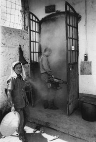 A photograph of Cpl Jim Henry of the 1st Australian Civil Affairs Unit, Nui Dat, South Vietnam carries out decontamination of Baria Jail. 