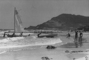 A photograph of Cape St Jacques 'Back Beach'. Medics from 1st Australian Field Hospital enjoying a few hours off duty sailing and surfing.  