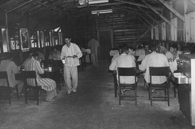 A photograph at the 1st Australian Field Hospital, ambulatory patients from the hospital wards enjoy a meal in the hospital mess. 