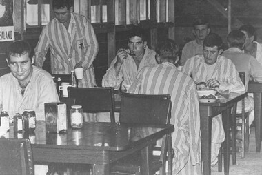 A photograph at the 1st Australian Field Hospital, ambulatory patients from the hospital wards enjoy a meal in the hospital mess. 