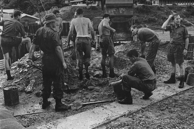 Officers, Andrew Smith, Rob Moreton, Roger Nation and Terry Casey, scratches his head trying to understand the task of filling sandbags .