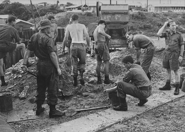 A very heavy sandbag detail at the 1st Australian Field Hospital, here Doctors, Dentists and Pharmacists fill sandbags for their accomodation protection. 