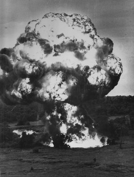 N.W. of 1st Australian Task Force Base, 44 gallon drums of high octane fuel exploded into a fireball as Australian troops clear NVA/VietCong rice paddies.