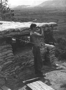 131st Battery, 1st Fld Regt, RAA , Gnr Ben Lombardo scans 1st ATF perimeter with high powered binoculars while Gnr Cahill mans his SLR 