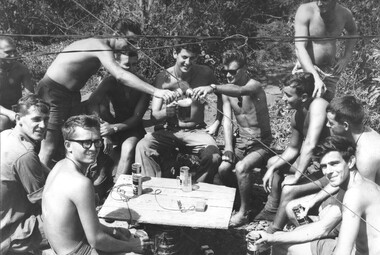 At 131st Divisional Locating Battery, 1st Fld Regt , RAA, off duty gunners fill Gnr Ben Lombardo's "pint" mug, to toast his 21st birthday. 