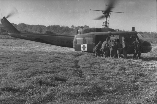 Diggers from 11 Platoon, D Coy, 6 RAR on Operation Portsea load Pte Ken Mathieson into an American Dustoff helicopter for casevac to hospital.