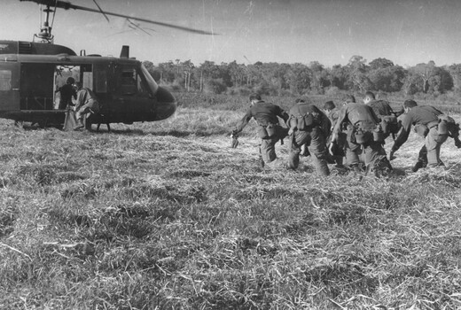 Diggers from 11 Platoon, D Coy, 6 RAR on Operation Portsea carry Pte Ken Mathieson into an American Dustoff helicopter for casevac to hospital.