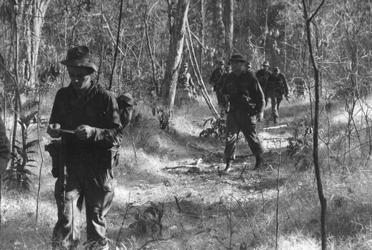 Diggers from 11 Platoon, D Coy, 6 RAR on Operation Portsea carry wounded mate Pte Ken Mathieson to be picked up by Dustoff helicopter. 