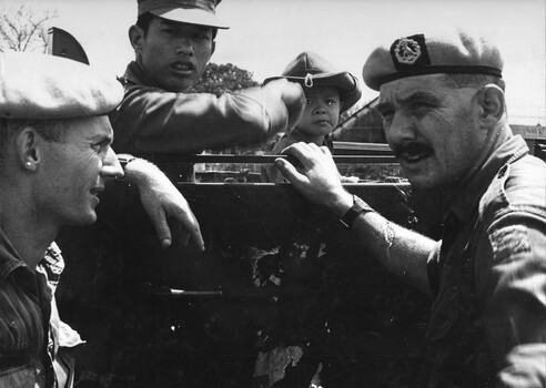 Squadron Sergeant Major, WO2 Brian Quee, and 2Lt Mike Meehan of 161 (Indep) Recce Flight with a Vietname Interpreter and his son . 