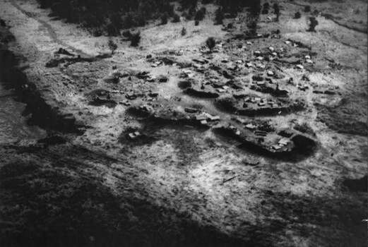 A photograph of an oblique aerial view of an Australian Fire Support Base at the base of the Nui Thai Van Hills. 