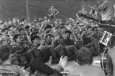 Johnny Mack of the Official Sep-Oct 69 Lorrae Desmond Show, at the 1st Australian Task Force Base, enertaining the Diggers with country and western songs.