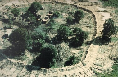 A fortified base camp alongside an Australian Fire Support Base, houses engineers involved in the construction of 'fire trails' through dense jungle. 