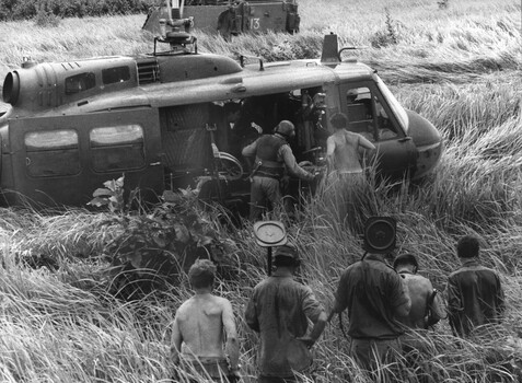 A photograph of a RAAF helicopter from 9 Sqn loads wounded Diggers following the destruction of APC 13A during operation Massey Harris.