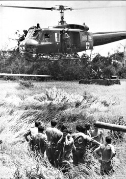 An American Dustoff helicopter prepares to land to collect some of the fifteen Diggers wounded by a massive 40lb mine blast under APC 13A. 