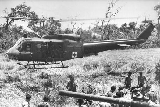 An American Dustoff medical evacuation helicopter, flies out fully laden with wounded Digger following the destruction of APC 13A 