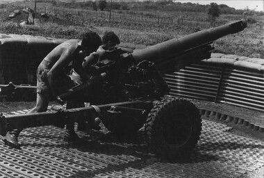 Diggers at 103 Battery, load a 105mm Italian Pack Howitzer during a fire mission from the 1st Australian Task Force Base, Nui Dat. 