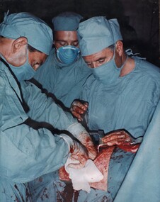 Surgeon Ed Carr conducts a laporotomy on a mine explosion patient assisted by Wg Audio, CDr Alan Beech and medic Cpl Peter Whittle. 