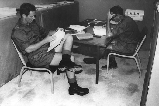 During a lull in casualties 1st Australian Field Hospital, Maj Andrew Smith and  Lt Col Ian Miller catch up on some technical data. 