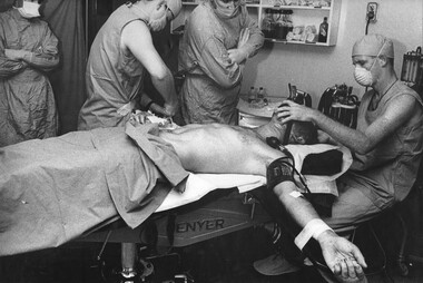 In the operating theatre at the 1st Australian Field Hospital, a surgeon waiing to perform the operation on an American Helicopter Pilot suffering with burns.