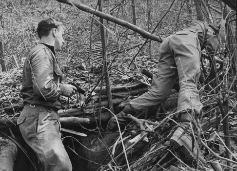 A photograph of an Engineer 'Tunnel Rats' prepare to blow a NVA/VietCong bunker complex and its connecting tunnels. 