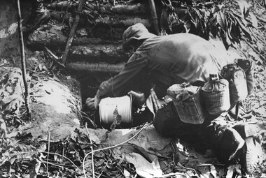 A photograph of Engineer 'Tunnel Rats' prepare to enter a NVA/VietCong bunker complex, and its connecting tunnels to check the underground area for enemy.