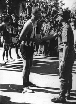 Trooper Jack Thurgar 1st Special Air Squandron is congratulated by Col Tu after being presented with the winners trophy following his first place win. 