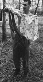 Private Jack Higgins combat batsman to Maj Jake O'Donnell A Comapny, 7 RAR hangs out his boss' washing on a telephone wire clothesline.