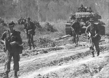 Diggers of 1st Battalion, Royal Australian Regiment, conducting Operation Goodwood move out with Centurian tank support from 1st Armoured Regiment. 