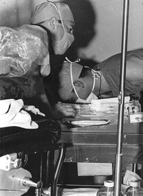 Two 1st Australian Field Hospital medics collect and prepare medical supplies, instruments and other equipment for removal from the operating theatre following surgery.