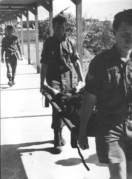 A wounded enemy VietCong soldier is being taken to the 1st Australian Field Hospital Vung Tau, South Vietnam by two Corporal medics.  