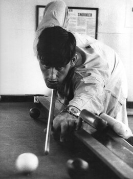 Pte Henderson, a wounded scout of 8 RAR, enjoys a game of snooker in the Red Cross hut at the 1st Australian Field Hospital. 