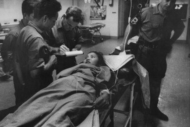 At the 1st Australian Field Hospital, watched by an Australian MP,  South Vietnamese Army Intelligence Officers question a VietCong prisoner.