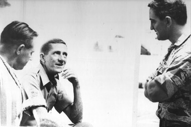 A member of the AATTV is visited by colleagues as he waits to be loaded into an ambulance for the trip to the Airfield. 