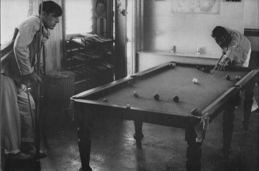 Pte Henderson, from 8 RAR enjoys a game of pool with a fellow patient in the Red Cross hut at 1st Australian Field Hospital. 