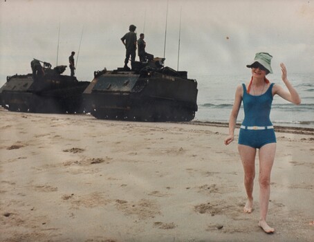 Lt Patricia Ferguson walks up 'Back' beach after talking to her brother Trooper Peter Ferguson the driver, seen bending over the left most APC. 