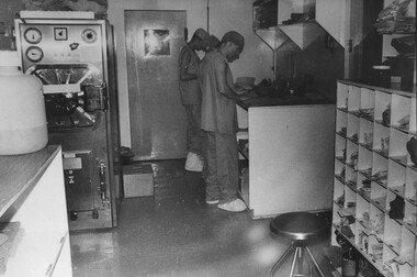 In the 1st Australian Field Hospital, autoclave room medics John Tulloch and Peter Carey assist Capt Fay Lewis in preparing medical and surgical packs. 