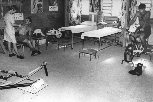 While Physiotherapist Lt Sue Wooley in the 1st Australian Field Hospital, in the Physio hut discusses treatment for the seated digger. 