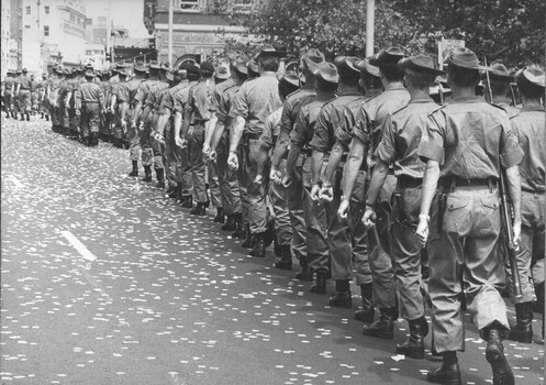 George St, Sydney, NSW, Australia 1971. Diggers ofthe 7th Battalion, the Royal Australian Regiment, march through the city of Sydney, through a ticker tape welcome.