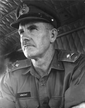 The Commander, Australian Force Vietnam, Maj Gen Doug Vincent peers purposely ahead as he flies, in his personal helicopter from Saigon. 