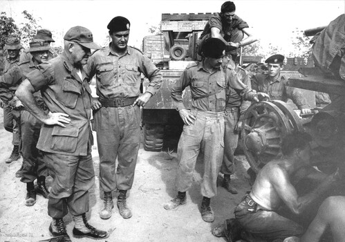 General Creighton Abrams, OC Military Assistance Command Vietnam accompanied by Maj Aalan Vickers and watched by the 1st ATF Brig C M I Sandy Pearson.