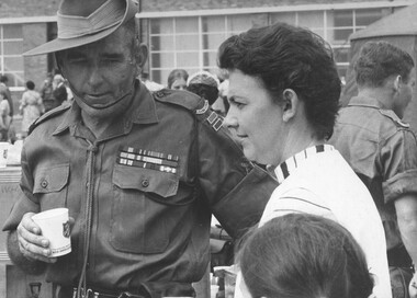 WO1 Reginald Amos Bandy MBE, Regimental Sgt Maj of 7th Battalion, RAR is met by his wife on arrival at the Garden Island Naval Base.