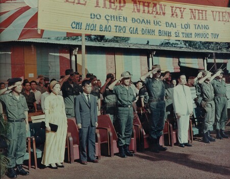 1st ATF Deputy Commander accompanied by the CO of 1st Australian Civil Affairs Unit salute the South Vietnamese flag. 