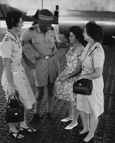 Mrs Pearl Copeman the mother of seriously wounded Digger Pte Russell Copemen under the wing of an RAAF C130 Hercules Medivac aircraft. 