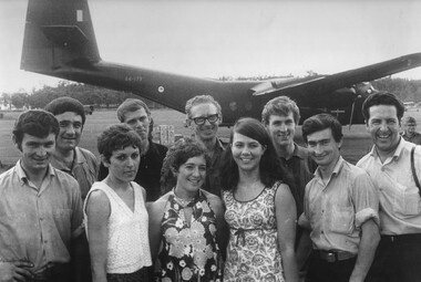 Musicians of the Official Jun 69 Tasmanian Concert Party pose in front of their RAAF Caribou transport.