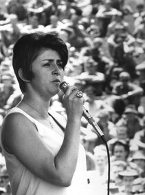 Glenise Shearman is engrossed in her rendition of a song to the assembled Diggers at 1 ATF Base Nui Dat, Luscombe Bowl.