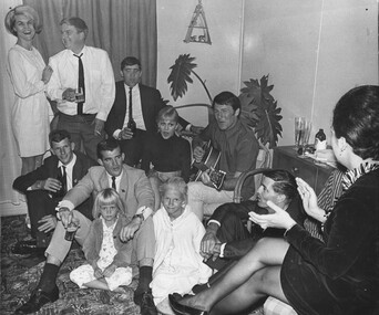 In Townsville, rock and roll stars Little Pattie and Col Joye entertain at a private home with members from Delta Company 6 RAR. 